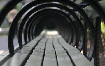 looking through the round handles of park benches